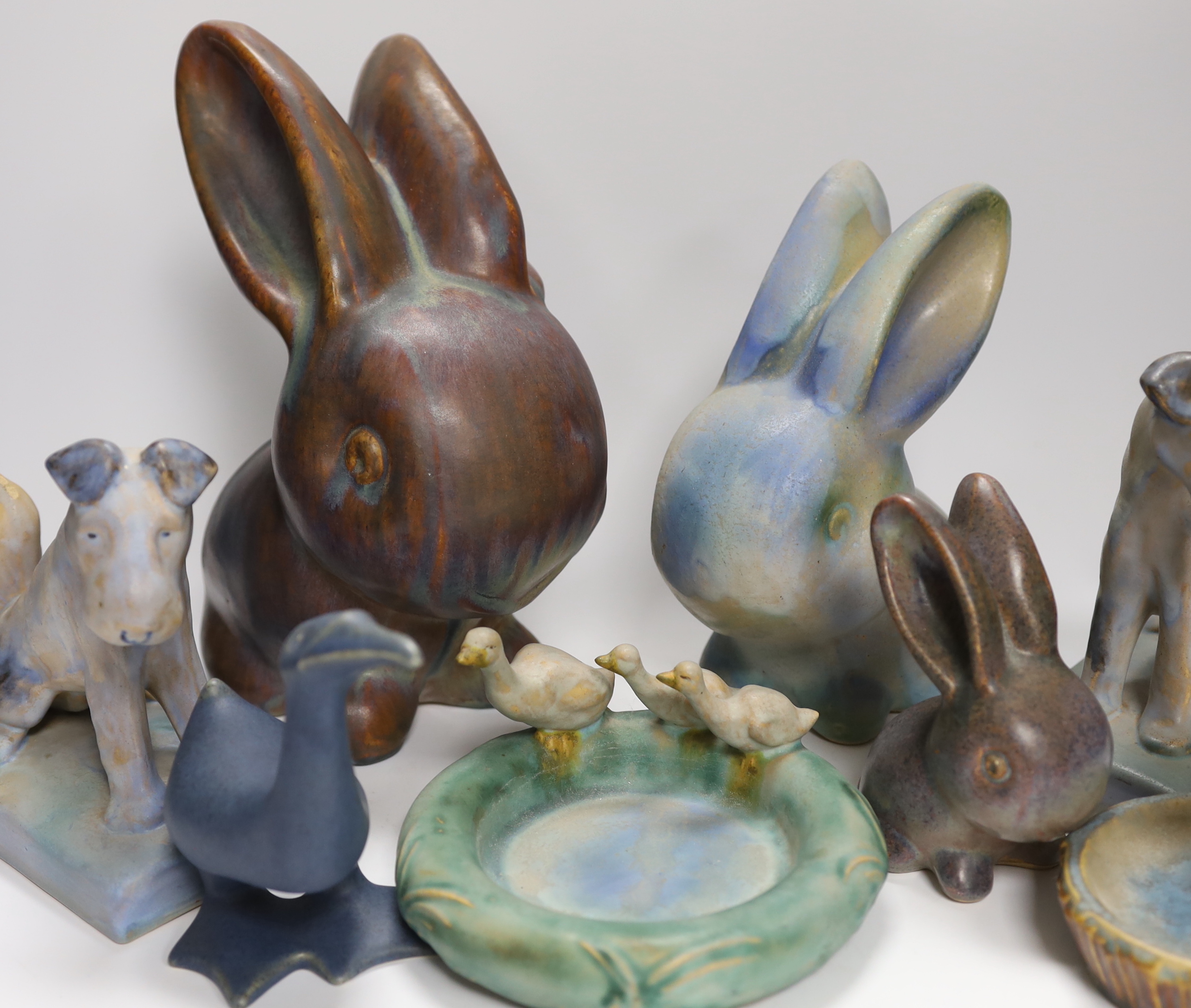 Collection of Bourne Denby animals including rabbits and a pair of dogs, tallest 27cm